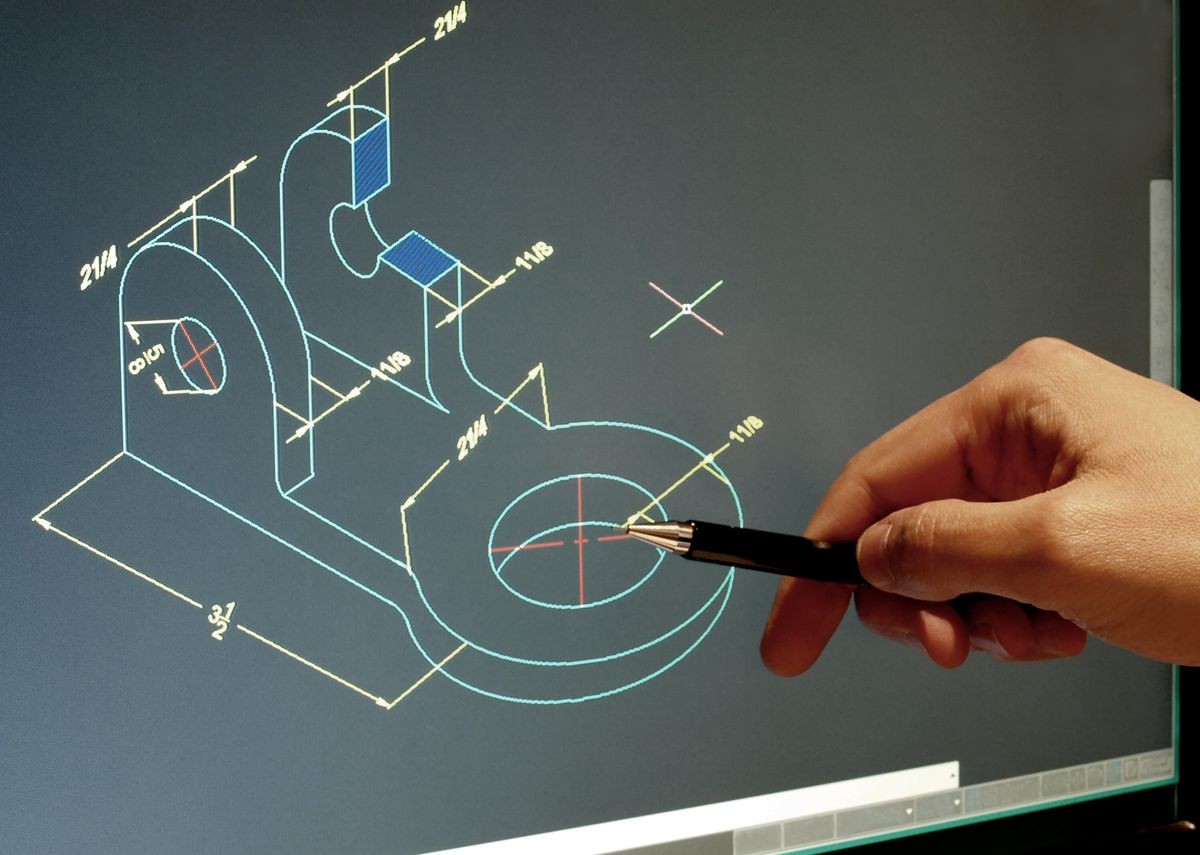 engineer working at computer on mechanical piece design